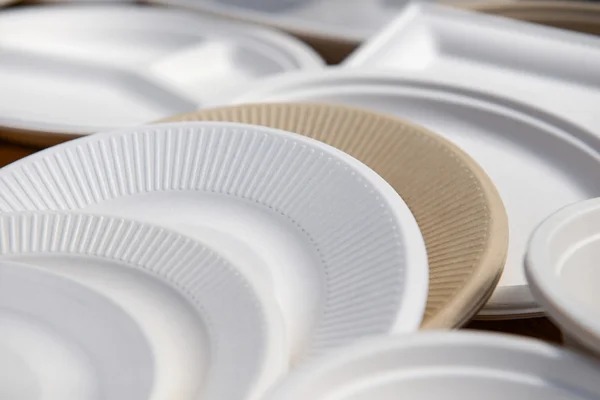 Propose new materials or technologies to make paper products waterproof and grease proof